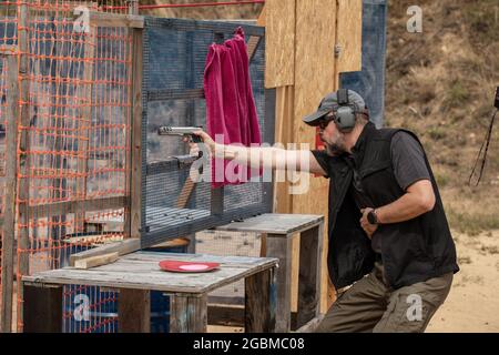 Reload Gun Range Image Man reloading gun on black background, closeup Stock Photo - Alamy