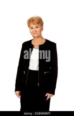 Portrait of an elegant old Polish woman wearing a black suit, posing against white background Stock Photo
