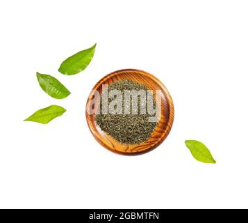 Dried organic tarragon leaves in wooden bowl - Artemisia dracunculus Stock Photo