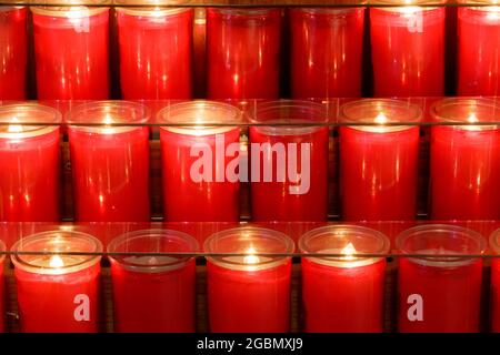 Prayer candles burning inside a church in Northern California Stock Photo