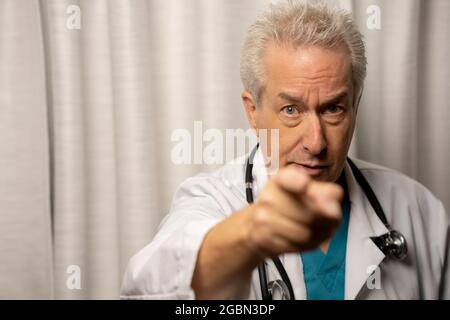 Photo of a doctor pointing his finger at you Stock Photo