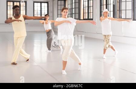 People practicing vigorous lindy hop movements in dance class Stock Photo