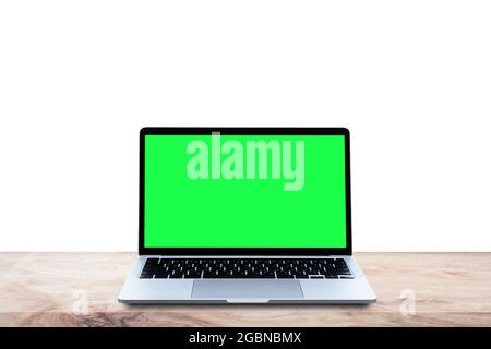 Mockup laptop computer blank green screen on wood table, Isolated on white background. Stock Photo