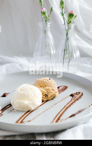 Ice cream balls on a plate with chocolate syrup Stock Photo