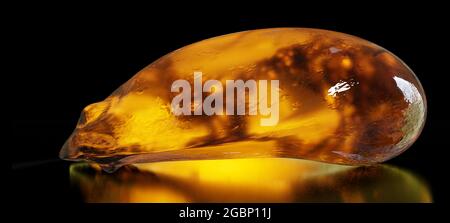 amber, natural fossilized tree resin isolated on shiny black background Stock Photo