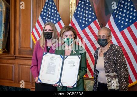 Speaker of the United States House of Representatives Nancy Pelosi (Democrat of California), center, is joined by United States Representative Jennifer Wexton (Democrat of Virginia), left, and Delegate Eleanor Holmes Norton (Democrat of the District of Columbia), right, for a bill enrollment photo opportunity for H.R. 3325, to Award Congressional Gold Medals to USCP and Those Who Protected the U.S. Capitol on January 6th, at the US Capitol in Washington, DC, Wednesday, August 4, 2021. Credit: Rod Lamkey/CNP/Sipa USA Stock Photo
