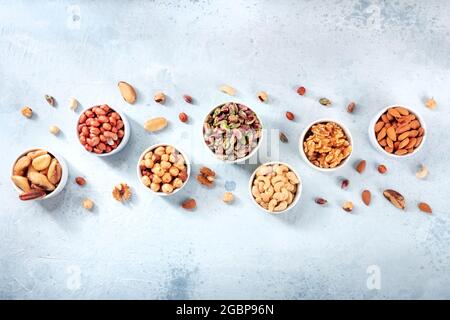 Nuts. overhead flat lay composition with bowls of various culinary nuts, with a place for text Stock Photo