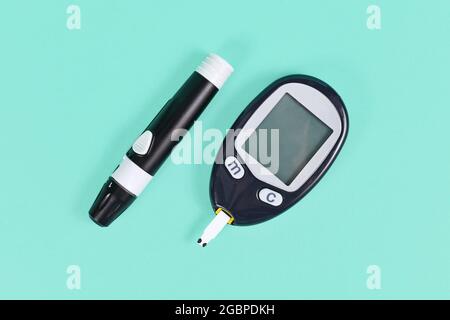Diabetes treatment tools with blood glucose sugar meter and lancing device with lancet Stock Photo
