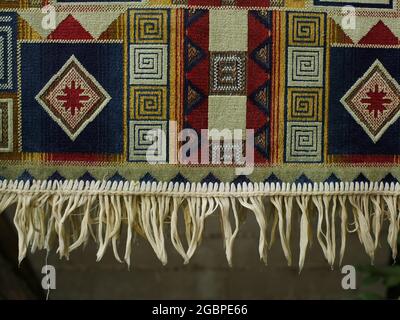 colored rug with fringe dries after washing close-up Stock Photo