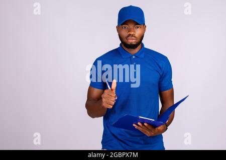 black delivery worker holding a manifest, does a thumbs up gesture Stock Photo