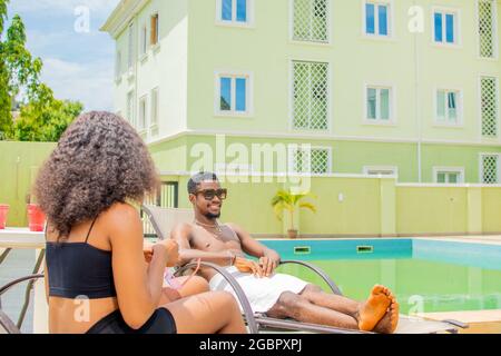 young black people chilling by the pool side Stock Photo