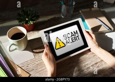 Scam alert detecting warning. Notification on device screen Stock Photo