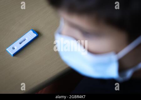 05 August 2021, Hamburg: A pupil in class 6a at the Goethe-Gymnasium in Hamburg-Lurup takes a Corona quick test in the classroom on the first day of school after the holidays. After around six weeks of summer holidays, Hamburg's pupils started the new school year on Thursday, 05.08.2021 - for the second time under Corona conditions. Among other things, compulsory testing and masks for the children and adolescents as well as an extensive hygiene and ventilation concept continue to apply. Photo: Christian Charisius/dpa Stock Photo