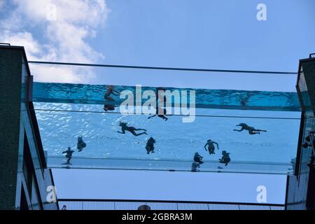 London, United Kingdom. 5th June 2021. People in the newly opened Sky Pool, a swimming pool suspended 35 metres above ground between two apartment buildings next to the US Embassy in Nine Elms. Believed to be the world's first swimming pool of its kind, it is open to residents only. Stock Photo