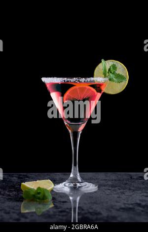 Pink margarita cocktail in a cocktail glass and a slice of lime Stock Photo