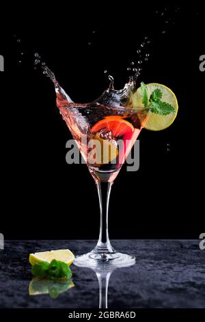 Pink margarita cocktail in a cocktail glass and a slice of lime Stock Photo