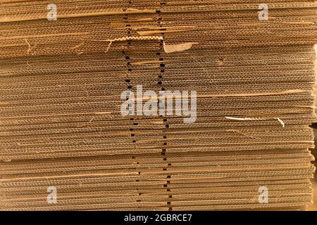 Stack of flattened corrugated cardboard cartons (packing boxes) used for packing when moving house. Stored ready fo next move, Australia. Background. Stock Photo