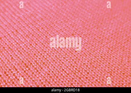 Coral Pink Knitted Wool Fabric in Diagonal Patterns for Abstract Background Stock Photo