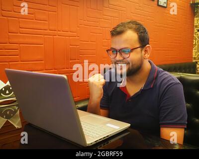 Close up smiling  man wearing glasses using laptop Stock Photo