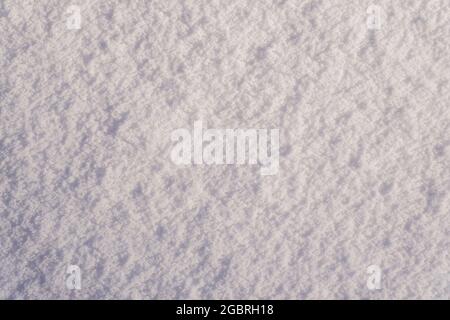 Snow texture as winter background. Smooth surface of clean fresh snow. Snow patterns. Stock Photo