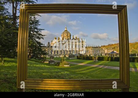 A framed view of the dome and South (garden) front  of Castle Howard, North Yorkshire, England photographed in Autumn sunshine. Stock Photo