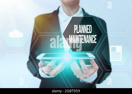 Sign displaying Planned Maintenance. Concept meaning reventive maintenance carried out base on a fixed plan Lady In Uniform Holding Phone And Showing Stock Photo