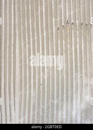 Texture of troweled cement with parallel vertical lines and grooves Stock Photo