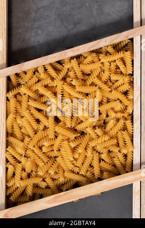 Raw pasta in asymmetrical boxes, space for text Stock Photo