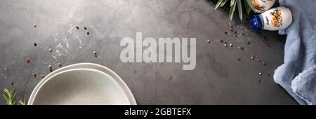 Dark food background with empty cement plate and spices Stock Photo