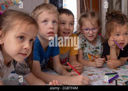 children painting with penclis, crayons on table Stock Photo