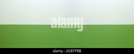 Wide cement wall painted green and cream color background for design in your work concept. Stock Photo