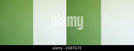 Wide cement wall painted green and cream color background for design in your work concept. Stock Photo