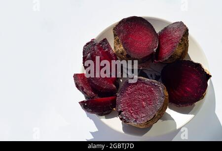 Baked beetroot. The halves are on a plate. Stock Photo