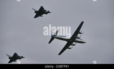 Zeltweg, Austria SEPTEMBER, 6, 2019 Propeller airliner from the 1950s is intercepted by modern military fighters. Douglas DC-6 of Yugoslavian Prime Minister Josip Broz Tito with Eurofighter Typhoon Stock Photo