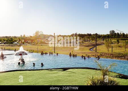 FEDERACION, ENTRE RIOS, ARGENTINA - FEBRUARY 25, 2021: View of the one of many hot spring swimming pool of the complex. The people bathing in the hot Stock Photo