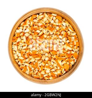 Dried organic orange peel, cut into coarse pieces, in a wooden bowl. Cut skin of organic oranges, used for baking, or for teas. Stock Photo