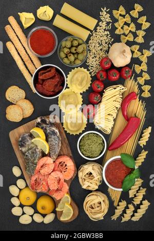 Italian low cholesterol food ingredients for healthy diet with prawns,  oysters, pasta, fruit, vegetables, sauces, bread products. Stock Photo