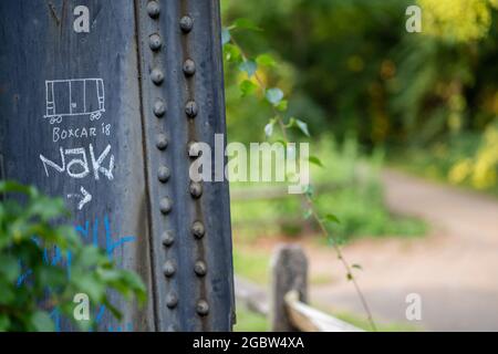 LYNCHBURG, UNITED STATES - Jul 23, 2021: An old black and rust iron train trestle near the Blackwater Creek Hiking trail in Lynchburg, Virginia Stock Photo