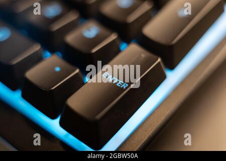 LYNCHBURG, UNITED STATES - Jul 22, 2021: A macro shot of an enter key on a gaming keyboard with blue lighting Stock Photo