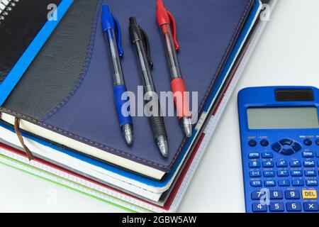 school tool set ready for back to school with notepad, pens, markers and calculator on white background Stock Photo