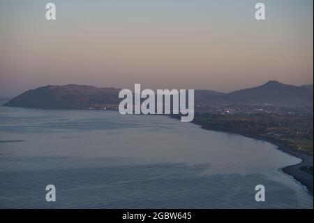 Beautiful evening view of Killiney Beach, Bray Head and Little Sugar Loaf seen from Killiney Hill during golden hour, Dublin, Ireland. Soft and select Stock Photo