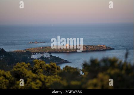 Beautiful evening view of Sorrento Point, Dalkey Island and Muglins Lighthouse from Killiney Hill during golden hour, Dublin, Ireland. Soft focus Stock Photo