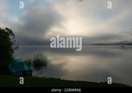 An early morning at Lac de Joux, Switzerland: Beautiful scenery with fog and the rising sun Stock Photo