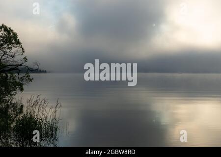 An early morning at Lac de Joux, Switzerland: Beautiful scenery with fog and the rising sun Stock Photo