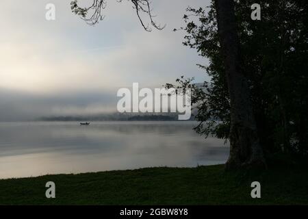 An early morning at Lac de Joux, Switzerland: Beautiful scenery with fog and the rising sun Stock Photo