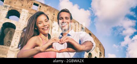 Rome romantic travel destination happy couple in love making heart shape hands showing romance getaway for honeymoon holiday panoramic banner Stock Photo