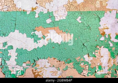 Decayed wall with peeling green paint forms abstract background Stock Photo