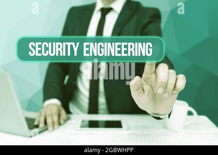 Writing displaying text Security Engineering. Internet Concept focus on the security aspects in the design of systems Bussiness Man Sitting Desk Stock Photo