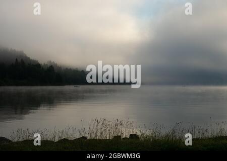 An early morning at Lac de Joux, Switzerland: Beautiful scenery with fog during sunrise Stock Photo