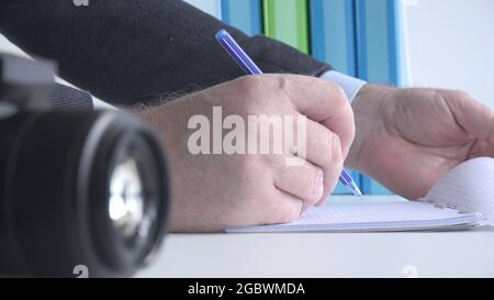 Close Up Image with a Businessman at Workplace Taking Notes Stock Photo